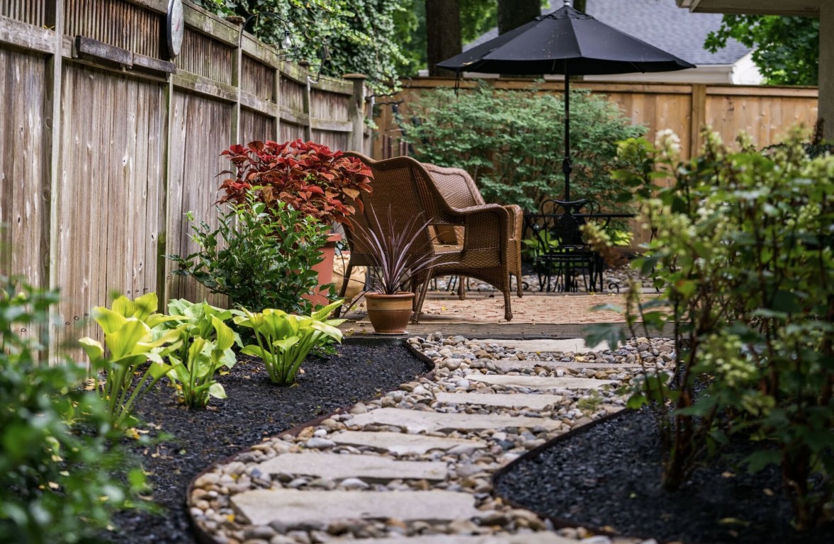 Professional stepping stone pathway installation in backyard
